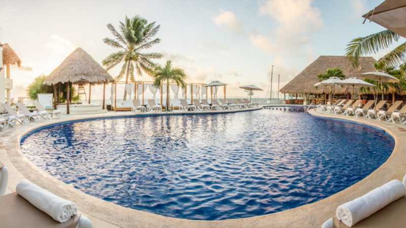 Ground level view of the main pool at Desire Resort and Spa Riviera Maya